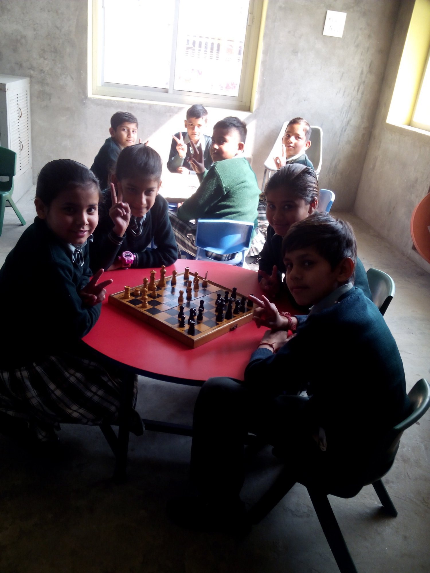 Happy students at chess table