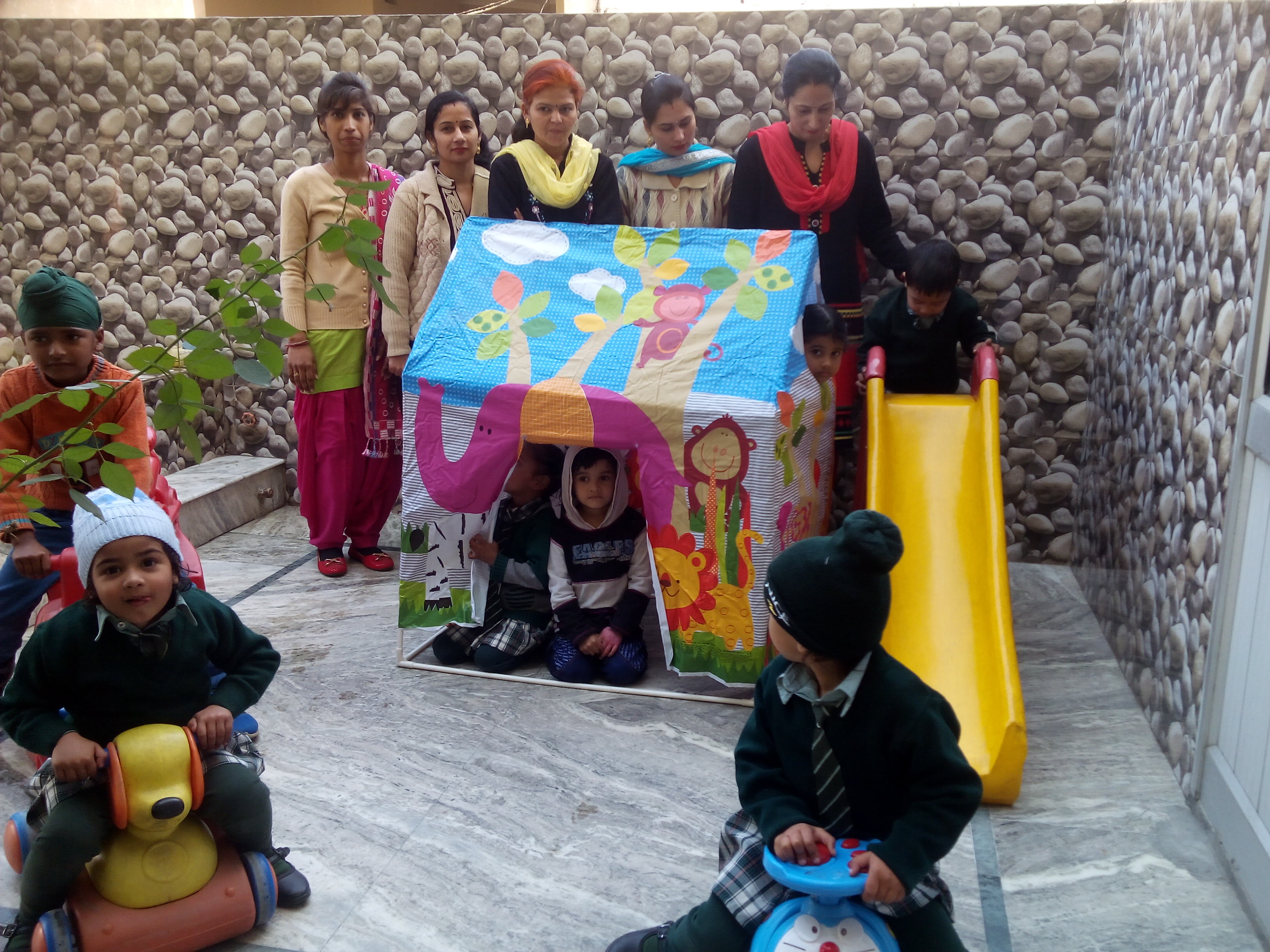 Teachers and kids in play area