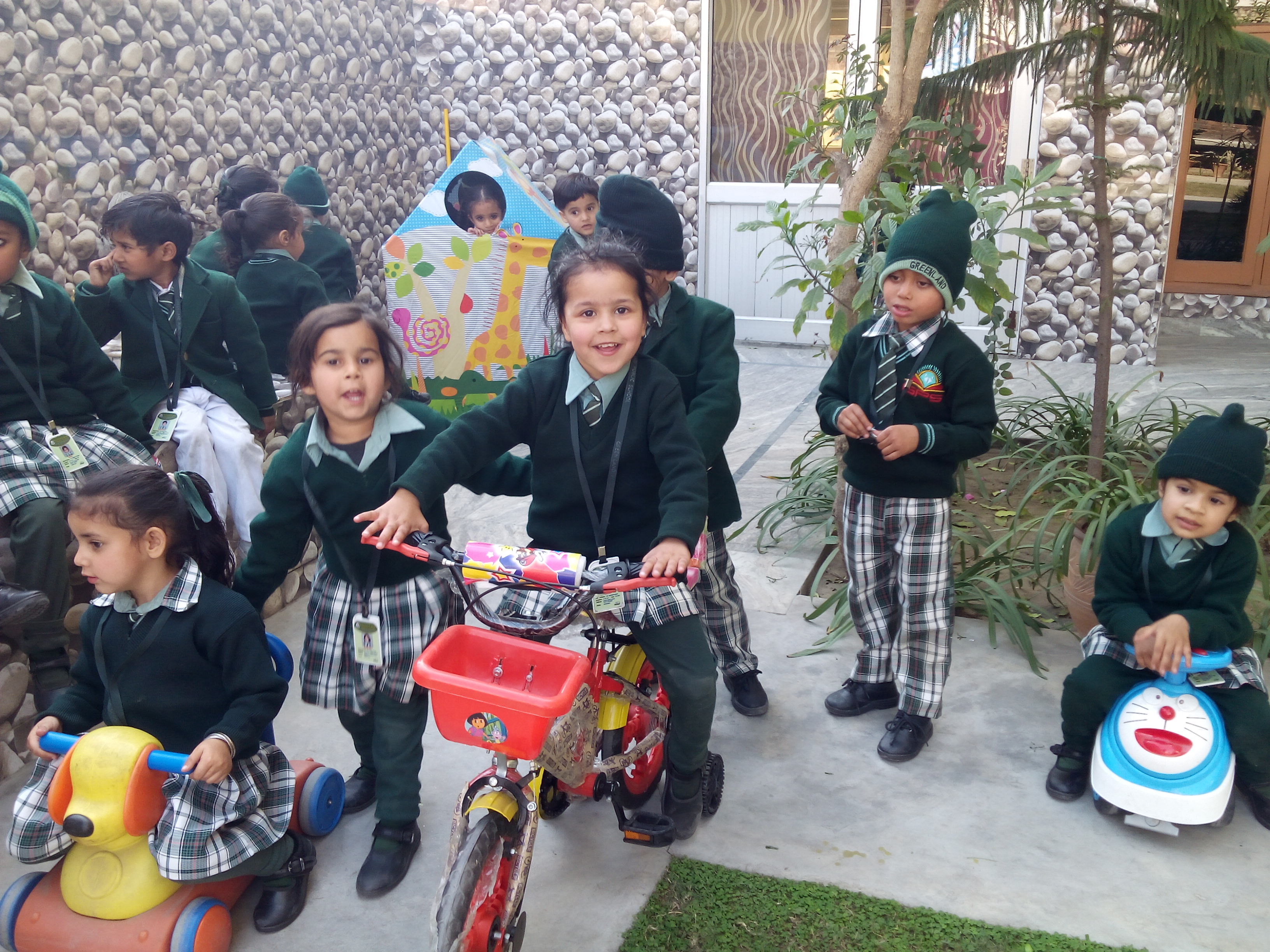Children on bicycles in courtyard