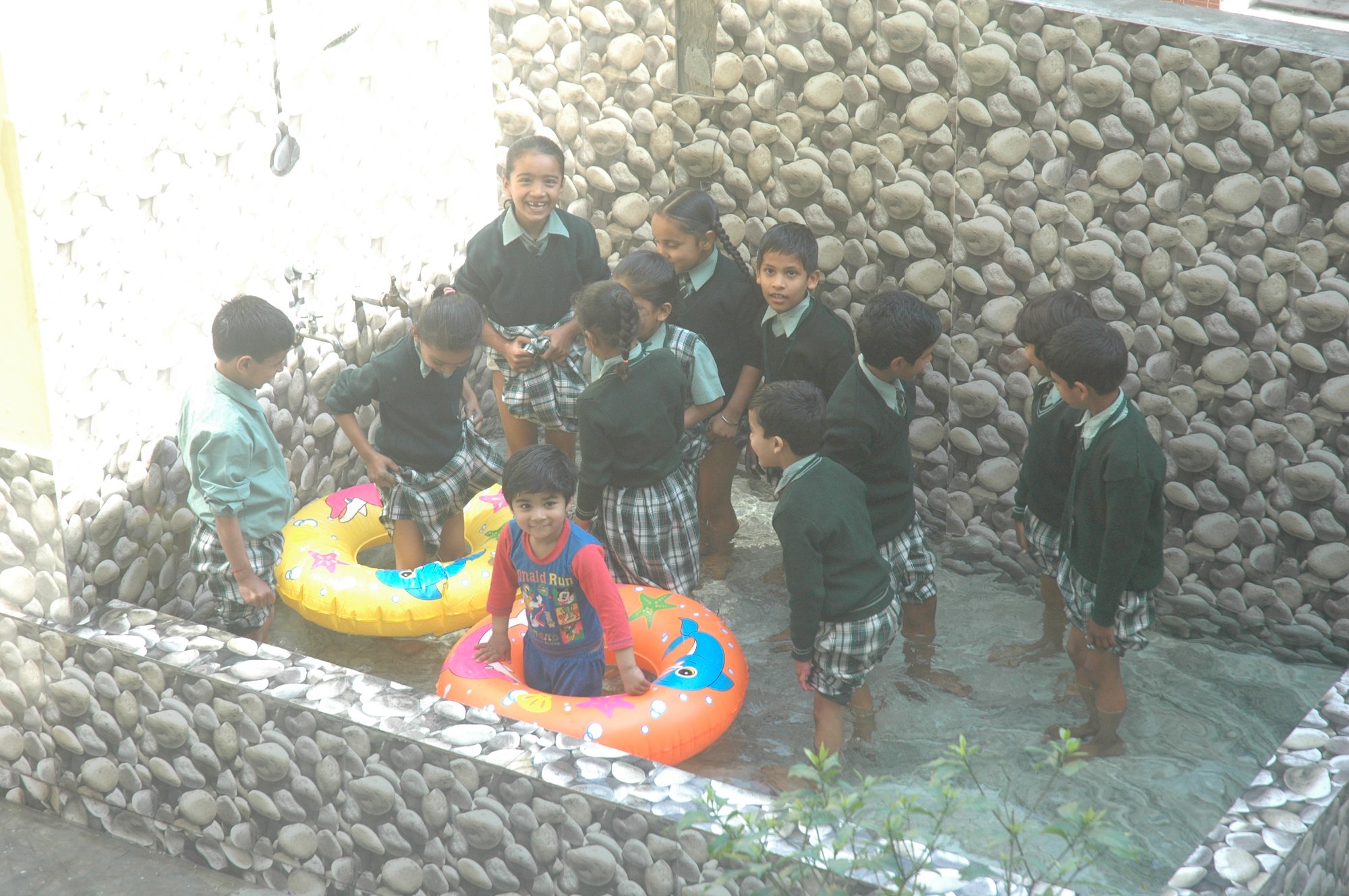 Children enjoying splash pool in play area